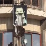 Picture of Assad's poster being torn down